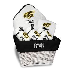 a white basket filled with towels and personalized items for the ryan football team, on a white background