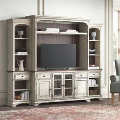 a living room with a large entertainment center