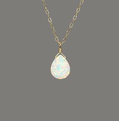 "Opal necklace, fire opal drop necklace, sparkly gem necklace, opal teardrop necklace, dainty 14k gold filled chain A super flashy opal drop is wire wrapped onto a 14k gold filled chain or sterling silver chain in the length of your choice! The teardrop measures 10mm x 8mm. More from BubuRuby? https://www.etsy.com/shop/BubuRuby?ref=hdr_shop_menu Looking for other charm necklaces? https://www.etsy.com/shop/BubuRuby?section_id=12318467 Raw crystal necklaces? https://www.etsy.com/shop/BubuRuby?sect Minimalist Teardrop Opal Jewelry, Dainty Teardrop Wire Wrapped Necklace, Dainty Wire Wrapped Teardrop Necklace, Dainty Teardrop Opal Necklace, White 14k Gold Filled Teardrop Necklace, Handmade Opal Teardrop Necklace, Gift Teardrop 14k Gold Filled Drop Necklace, Sun And Moon Necklace, Necklace Opal