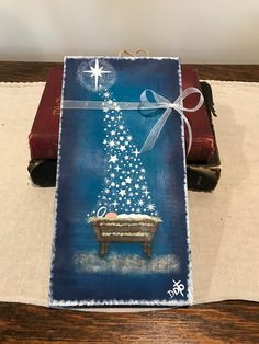 a christmas card on a table next to an open book