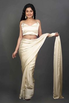 Experience the epitome of elegance with our Tia Cream Monochrome Cream One Minute Saree, crafted from luxurious satin fabric. Wear this luxurious saree for your next event or adorn your besties in this as the perfect Bridesmaid's saree! The saree's rich texture and delicate drape create a mesmerizing silhouette that exudes grace and sophistication. Perfect for special occasions or festive celebrations, this saree adds a timeless charm to your ensemble, making you the center of attention. Product Elegant Fitted Pre-draped Saree For Wedding, Elegant Silk Pre-draped Saree For Festive Occasions, Silk Pre-draped Saree With Dupatta For Party, Glamorous Draped Wedding Set, Glamorous Silk Sets With Sheer Dupatta, Elegant Formal Art Silk Pre-draped Saree, Elegant Silk Pre-draped Saree For Wedding, Festive Satin Pre-draped Saree For Formal Occasions, Formal Katan Silk Pre-draped Saree With Dupatta