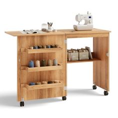 a sewing machine sitting on top of a wooden table next to a shelf filled with craft supplies