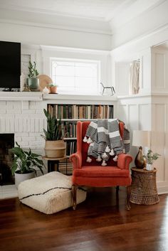 a living room filled with furniture and a fire place next to a bookshelf