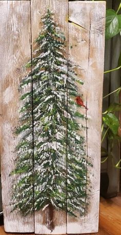 a wooden sign with a christmas tree painted on it