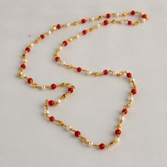 Embrace the allure of tradition with our Coral Pearl Necklace--a fusion of antique charm and Jaipuri elegance. This Mala set, a blend of traditional and fancy elements, features vibrant coral color beads and lustrous pearls. The necklace exudes sophistication, complementing any outfit effortlessly.  This personalized jewelry piece is my own design, and I welcome any customization requests. Elevate your style with this exquisite Indian jewelry. Length - 30 inch Pearl Coral Necklace Indian, Coral And Pearl Jewellery, Pearl Chain Necklace For Diwali Gift, Temple Style Necklace With Pearl Chain As A Gift, Festive Fusion Gold Beaded Necklaces, Festive Fusion Style Pearl Necklace Gift, Temple Style Pearl Chain Necklaces For Festive Occasions, Temple Necklace With Pearl Chain As Diwali Gift, Traditional Beaded Chain Bridal Necklace