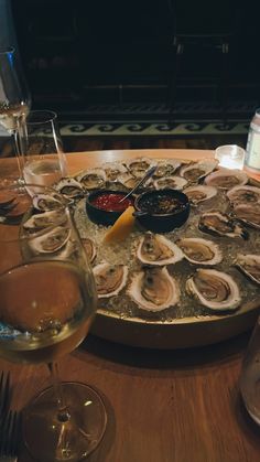 a table topped with wine glasses and oysters