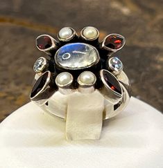 This beauty has a incredible moonstone in the center surrounded by garnet , clear quartz and pearls.  This is a size 8 Unique White Multi-stone Moonstone Ring, Multi Stone, Clear Quartz, Rings Statement, Ring Designs, Moonstone, Statement Rings, Garnet, Jewelry Rings