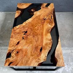 a table made out of wood and black glass