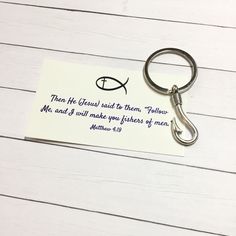 a keychain with a bible verse on it sitting on top of a table