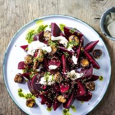 a white plate topped with beets covered in dressing