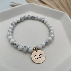 It's all about the "signs" with our Zodiac Bead Bracelet. These beaded beauties look great alone and even better in a bracelet stack. Mix and match and make them your own. They're perfect for gifting too, each bracelet comes ready to gift in our logo linen logo pouch and includes a zodiac card. 6mm gemstone beads hand cast bronze zodiac charms (1/2 inch) Zodiac Card + burlap logo bag included Ready to gift!! Ships within 1 to 2 business days. Inner Energy, Zodiac Cards, Different Zodiac Signs, White Howlite, Bags Logo, Hand Cast, Elevate Your Look, Initial Charm, The Signs