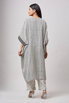 Ivory kaftan with hand block print and embroidery on the neckline and sleeves. Paired with a pant. - Aza Fashions White Printed Tunic Kurta, White V-neck Kurta With Printed Motifs, Printed Straight Kurta Kaftan, White Bohemian V-neck Sets, White Block Print Tunic Kurta, Traditional White Block Print Kaftan, Traditional Block Print Kaftan For Eid, Traditional White Kaftan With Block Print, Kurta With Printed Motifs And Kimono Sleeves