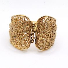 "DESCRIPTION: Step into the charm of the 1970s with this vintage gold-tone filigree bracelet. Crafted with meticulous attention to detail, the bracelet features intricate filigreed patterns adorning the entire piece. The centerpiece showcases a captivating butterfly accent, adding a whimsical touch to the design. In mint condition, this bracelet has been well-preserved over the years, maintaining its original allure. With a push-pull clasp for secure fastening, this bracelet measures 7 1/2\" in Heirloom Yellow Gold Bracelet With Filigree, Heirloom Yellow Gold Filigree Bracelet, Heirloom Style Gold Metal Bracelet, Ornate Yellow Gold Bracelets With Intricate Design, Ornate Yellow Gold Bracelet With Intricate Design, Victorian Filigree Bracelets In Yellow Gold, Gold Victorian Cuff Bracelet With Intricate Design, Victorian Yellow Gold Filigree Bracelets, Vintage Yellow Gold Cuff Bracelet With Intricate Design