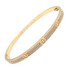 About This Piece: Discover the epitome of elegance with this Authentic Cartier 18k Yellow Gold Love Bangle. Symbolic screw motifs punctuate the warm, romantic hue of the bracelet, interlaced with brilliant-cut pave diamonds for captivating sparkle.... Trinity Bracelet, Love Bangle, Yellow Gold Bangle, Diamond Bangles Bracelet, Gold Bangle Bracelet, Fine Jewelry Bracelets, Diamond Bangle, Love Bracelets, Buying Jewelry