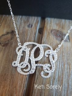 "Customize this beautiful necklace with your initials and it will shine with sparkling Cubic Zirconia stones. Great gift for birthday, graduation, Christmas, anniversary, etc.  Metal: Sterling Silver with Rhodium overlay Monogram size size is optional from 0.5\" to 2\" in diameter. Chain - standard link. Stones - CZ stones Traditional monograms are made with the following order of initials taken from your name: FIRST, LAST, MIDDLE We assume that this is the order that you want your initials in u Elegant Silver Initials Jewelry, Elegant Silver Jewelry With Initials, Formal Initials Jewelry With Cubic Zirconia, Formal Initials Cubic Zirconia Jewelry, Formal Initials Jewelry In Cubic Zirconia, Elegant Silver Initial Necklace With Monogram, Elegant Silver Initial Pendant Custom Necklace, Elegant Silver Initial Pendant Necklace, Elegant Silver Custom Necklace With Initial Pendant