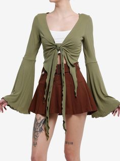 Look just like a fairy with this layering piece on! It comes in a forest green with wispy front-ties  and billowing bell sleeves for a whimsical look.95% rayon; 5% spandexWash cold; dry flatLength: 26"Cropped lengthStretchy materialImportedListed in junior sizesModel is 5'10"Model wears size Small 18th Bday, Bell Sleeve Crop Top, Green Tie, Green Outfit, Sweaters And Jeans, Hoodie Girl, Outfits Aesthetic, Look Cool, Bell Sleeve