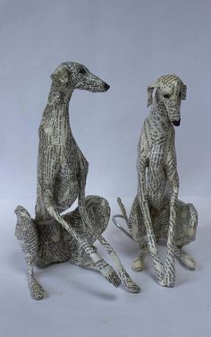 two paper mache dogs sitting next to each other