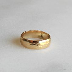 Thick Hammered Gold Band  Our thick hammered gold band ring is perfect for everyday! 14kt gold filled, this band is classic and timeless.  D E T A I L S -Hammered gold band - 5.5mm  -14kt gold filled  -snakeskin texture  D E T A I L S *Hammered gold band - 4mm *100% 14kt gold filled *Wear it plain or choose a special message for the inside CUSTOM HAND Engraving *Can be left blank or hand engraved *Inside is personalized in uppercase block letters or numbers *One character can be a heart or & sig Hammered Wide Band Rings For Everyday, Everyday Hammered Wide Band Jewelry, Everyday Wide Band Hammered Jewelry, Gold Hammered Thick Band Jewelry, Hammered Yellow Gold Rings For Everyday, Classic Hammered 14k Gold Stackable Rings, Classic 14k Gold Hammered Stackable Rings, Classic 14k Gold Stackable Hammered Rings, Adjustable 14k Gold Wide Band Ring