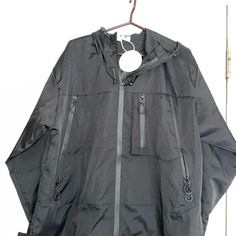 Very Nice Hooded Zip Up Men’s Windbreaker In A Size Large. I Cannot Find The Brand On This For The Life Of Me. Several Zipper Pockets And It Is Brand New. Please See Photos And If You Have Questions, Please Ask. Thanks For Looking. Have A Great Day. Black Weatherproof Hooded Sports Jacket, Black Utility Windbreaker For Outdoor, Black Weatherproof Hooded Jacket For Sports, Black Utility Hooded Jacket For Streetwear, Black Hooded Utility Track Jacket, Techwear Track Jacket With Double-lined Hood, Black Utility Hooded Jacket With Adjustable Hood, Black Utility Sports Outerwear, Black Sporty Weatherproof Hooded Jacket