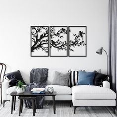 a living room with three paintings on the wall