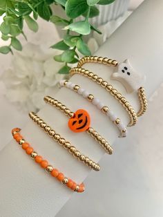 Halloween bracelets! Halloween Bracelet Stack. Pumpkin Bracelet. Ghost Bracelet Wear one or stack a bunch!! Bracelet length: 6.5 inches Bracelets are stretchy for a flexible fit! Materials Handmade Polymer clay pumpkin and ghost beads 4mm 14k gold plated round beads 4mm acrylic beads Elastic cord **ghost bead has a glittery finish Ghost Bead Bracelet, Cheap White Bracelet For Halloween, Adjustable Gold Bracelets For Halloween, Spooky Bracelet Ideas, Fall Braclets Ideas, Halloween Bead Bracelet, Halloween Beaded Bracelet, Fall Beaded Bracelets, Bracelet Buisness