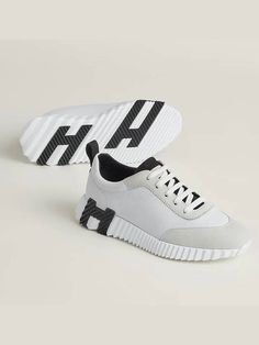 Gender: Women   Brand: HERMES   Product Name: Bouncing Low Top Sneakers Blanc Noir   Bags Alora Code: 80374413   Color: white   Composition: Goatskin Leather, Suede   Origin: France   Features: Rubber Sole   Designer Style ID H221176Z 90 Hermes Sneakers, H Logos, Hermes Shoes, Comfortable Sneakers, Low Top Sneakers, Black Ribbon, Designer Style, Black Rubber, Leather Sneakers