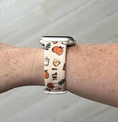 the apple watch band is decorated with pumpkins, leaves and other autumn things on it