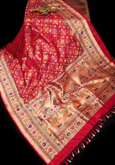 Indulge in exquisite heritage and rich culture with the Banarasi saree, a symbol of royal grandeur. This stunning fusion masterpiece combines intricate art by skilled karigars of Banaras. Adorned with floral and geometric motifs inspired by Meenakari Patola, this Red Tone Saree exudes unparalleled beauty. It is further enhanced by a Zari Paithani Border and Pallu, creating a luxurious and exclusive statement. SILK MARK CERTIFIED This saree is ready to wear with fall and pico done. Handmade silk tassels adorn the pallu and add more grace to it. An unstitched blouse fabric is included. *Note: There may be minor variations in the shade, the texture of the product. Hues/textures show differently due to variations in screen settings and other factors, *Note: This is a handwoven saree and there Brocade Saree For Ceremonial Use During Diwali, Ceremonial Shawl For Festivals, Transitional Paithani Silk Saree With Motifs, Transitional Paithani Silk Traditional Wear With Zari Weaving, Traditional Drape With Zari Weaving For Festivals, Traditional Wear With Zari Weaving For Festivals, Festival Brocade Saree With Zari Weaving, Traditional Drape Wear With Zari Weaving For Festivals, Traditional Draped Shawl With Motifs For Ceremonies