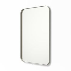 a white mirror hanging on the wall