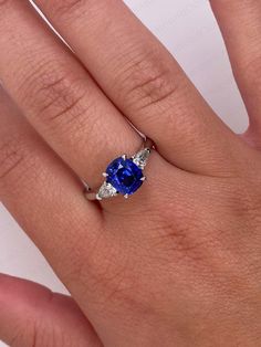 a woman's hand with a blue and white ring on top of her finger