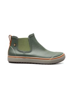 a green shoe with an orange rubber sole