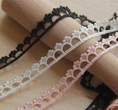 three different types of lace on wooden sticks