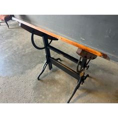 an old workbench sitting on top of a cement floor