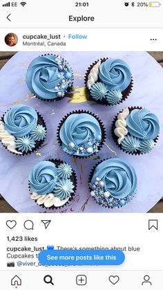 blue cupcakes sitting on top of a table next to an instagram post