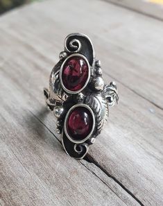 "Double garnet ring Beautifully detailed solid sterling silver(925) It weights 8-9 gms (depending on the size ) Length measures 30mm (1 1/4\") The 6 x8 dark red garnet cabochon stones are NOT SET UNTIL SOLD. I can make this with turquoise ,green or black onyx, cryhsophase or amethyst (amethyst is more expensive ) If a larger size is required more silver is used therfore there will be a slight increase. pls contact me first. I can also make this in gold" Gothic Art Nouveau, Star Garnet, Long Ring, Garnet Ring, Leaf Ring, Turquoise Green, Skull Ring, Garnet Rings, Gothic Art