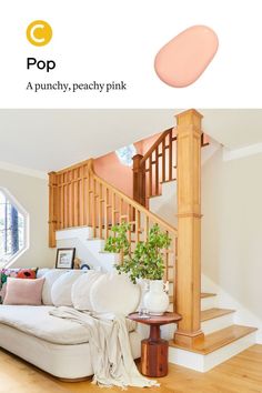 a living room filled with furniture next to a stair case and wooden bannister