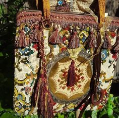 This embellished tapestry handbag  is very colorful . The bag is embellished with a vintage boho doily , with a lovely Victorian broach and tassel on top. Hanging from one handle are two tassels and hanging from  the other is a lovely brass magnify glass. This bag is very roomy with a shoulder strap.Tq Luxury Tapestry Bags With Top Carry Handle, Vintage Tapestry Multicolor Shoulder Bag, Vintage Tapestry Handmade Bags, Vintage Handmade Tapestry Bag, Bohemian Embroidered Tapestry Bags, Handmade Tapestry Shoulder Bag Rectangular, Bohemian Shoulder Bag With Detachable Handle, Vintage Everyday Bags With Tassels, Vintage Rectangular Fringe Bag