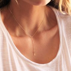 "Our dainty lariat necklace is stylish and minimalist. This dainty necklace is perfect with your favorite tee or your little black dress. A tiny bar adorns a silver or gold chain.  D E T A I L S *Dainty 12mm bar  *Hammered by hand  *2 inch drop  *Dainty link chain *100% 14kt gold-filled or sterling silver LENGTH *The standard length is normally 18\". *Model is wearing a 16\" in Photos. HOW TO PERSONALIZE *Select your choices from the drop down menu to create your custom design. ∙ EXTRA LOVE ∙ Ha Adjustable Rose Gold Lariat Necklace, Rose Gold Lariat Necklace With Delicate Chain, Dainty Adjustable Lariat Necklace, Dainty Lariat Necklace With Adjustable Long Drop, Adjustable Dainty Rose Gold Lariat Necklace, Adjustable Rose Gold Dainty Lariat Necklace, Minimalist Lariat Necklace With Delicate Chain, Dainty Adjustable Rose Gold Lariat Necklace, Dainty Long Drop Lariat Necklace With Adjustable Length