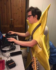 a man dressed as a banana using a computer