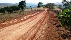 a dirt road in the middle of an open field