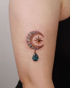 a woman with a star and crescent tattoo on her arm