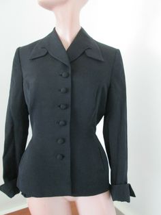 100% authentic vintage 1940s Herbert Hurwitz original San Francisco Black fitted jacket self fabric buttons cuffed wrist , two pockets botany virgin wool Condition no holes no rips, no stains Measurements taken flat approximately underarm to underarm 19" double fro circumference, across back shoulder seam to seam 15 1/2", across middle 14 1/2" double that, lower bottom hip 18" double that, sleeve uncuffed 24", jacket length from shoulder to bottom 24" Elegant Vintage Fashion Outerwear With Buttons, Retro Fitted Outerwear With Covered Buttons, Vintage Winter Blazer With Covered Buttons, Elegant Fitted Vintage Fashion Outerwear, Elegant Fitted Outerwear For Vintage Fashion, 1950s Fitted Workwear Outerwear, Tailored Vintage Outerwear With Covered Buttons, Vintage Solid Blazer With Button Closure, Vintage Outerwear With Covered Buttons For Work