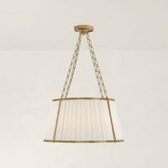 a chandelier hanging from the ceiling with a lamp shade on it's side