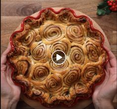 a person cutting into a pastry on top of a wooden table next to holly branches