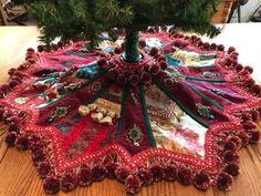 a christmas tree skirt sitting on top of a wooden table