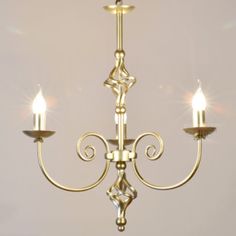 a gold chandelier with three candles on it