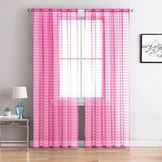 the pink curtains are hanging on the wall