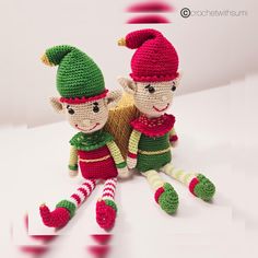 two crocheted elves sitting next to each other