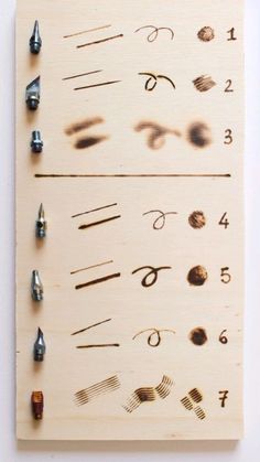 a wooden board with different types of nails on it