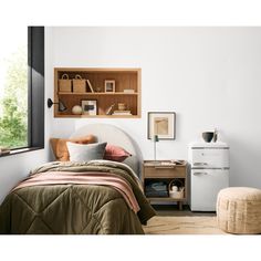 a bed room with a neatly made bed and a book shelf on the wall above it